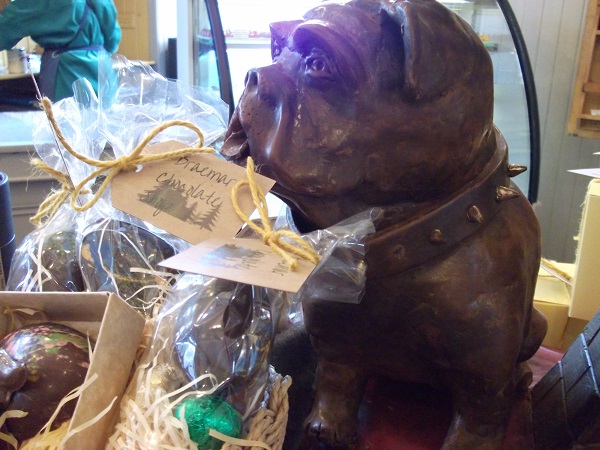 a dog ornament with chocolates around it