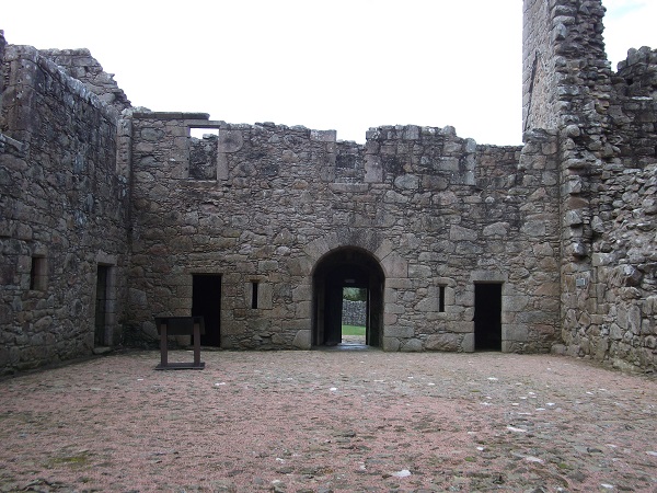 the ruined walls of a castle and its courtyard